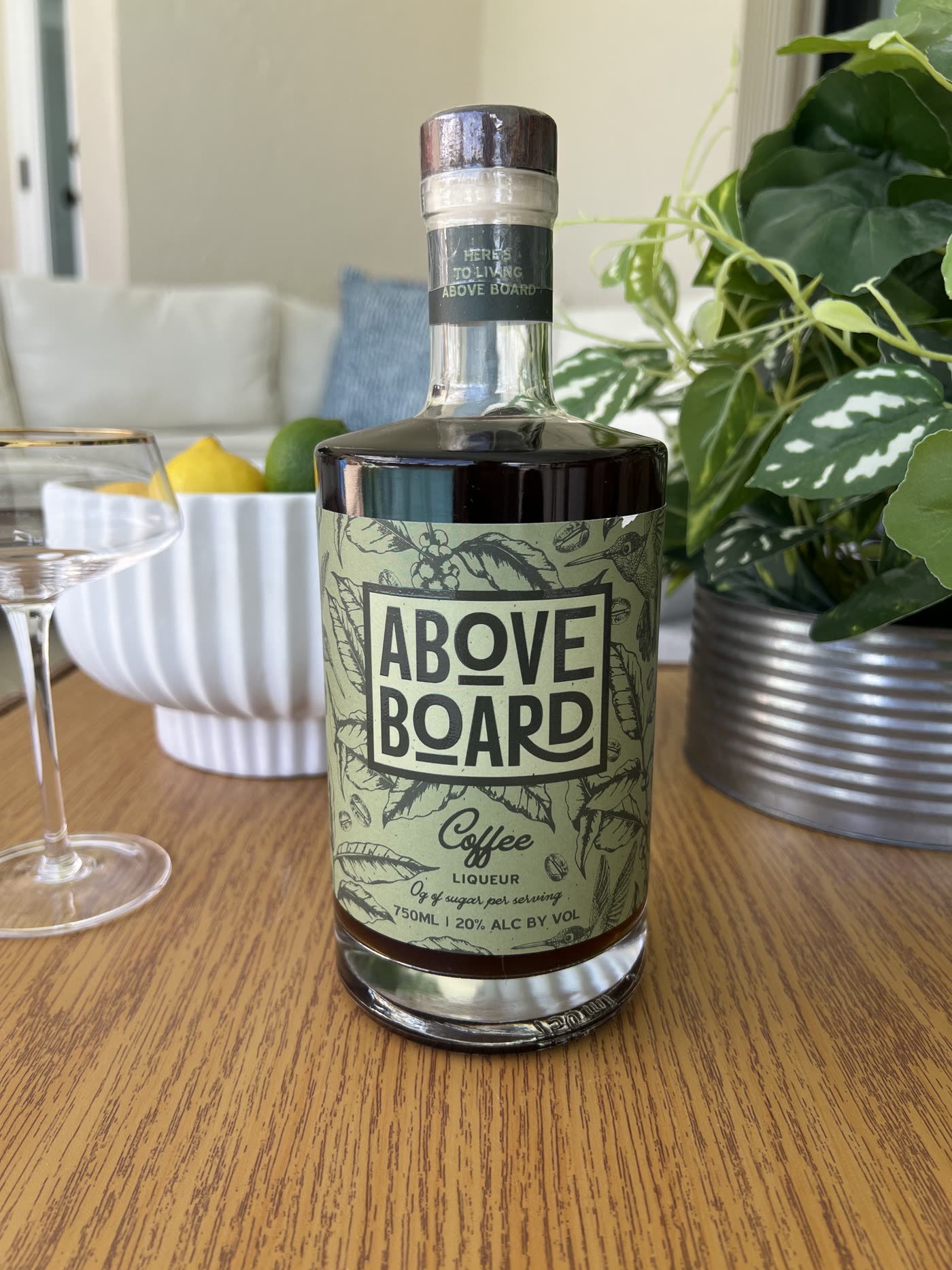 Above Board bottles, citrus, and coffee styled on a table