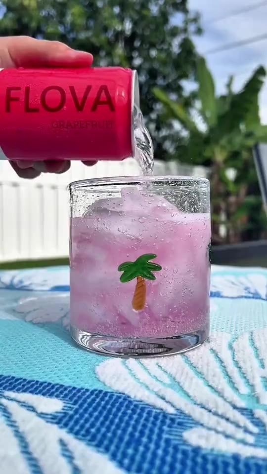 A pink Flova drink mixed beside the pool