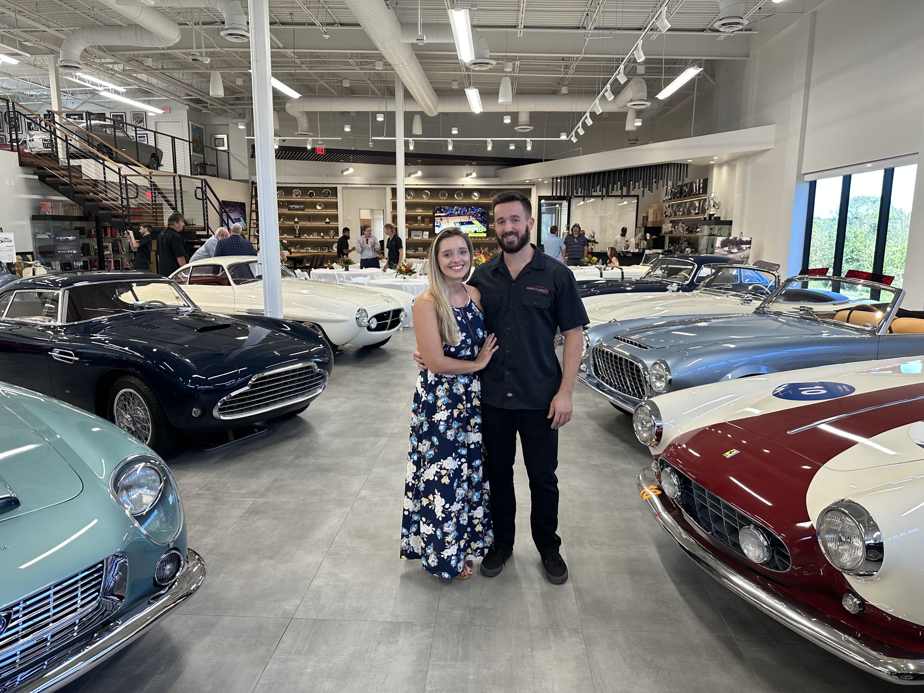 Ali and Justin, creators of The Well Loved Finds, together in a classic car showroom